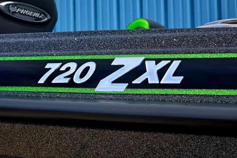 Slide: The Image of Close-up of Phoenix 721 ZXL boat model emblem, featuring sleek design and green accents. - 7