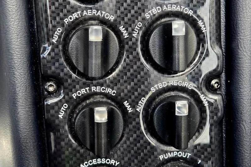 Slide: The Image of Control panel of a 2027 Phoenix 721 ZXL boat with aerator and recirculation switches. - 75