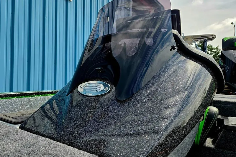 Slide: The Image of 2027 Phoenix 721 ZXL boat with sleek, glossy finish and windshield, parked near blue building. - 73