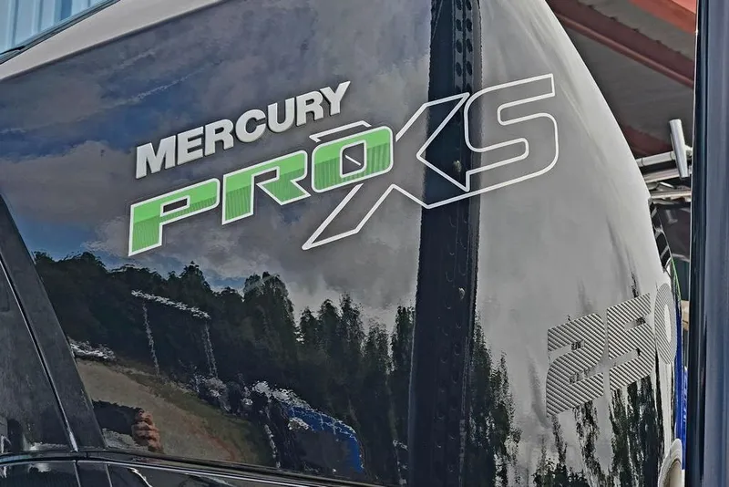 Slide: The Image of Mercury Pro XS 250 engine on 2027 Phoenix 721 ZXL boat, reflecting sky and trees. - 8