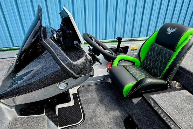 Slide: The Image of 2027 Phoenix 721 ZXL boat interior with green-accented seat and modern dashboard. - 38