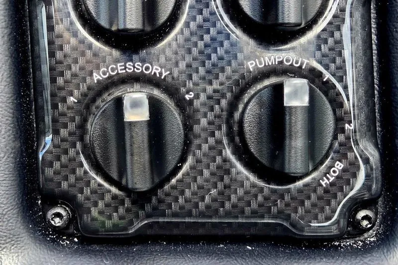 Slide: The Image of Close-up of 2027 Phoenix 721 ZXL control panel with carbon fiber texture and labeled switches. - 53