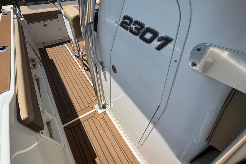 Slide: The Image of 2014 Century 2301 Center Console boat with teak flooring and sleek design. - 23