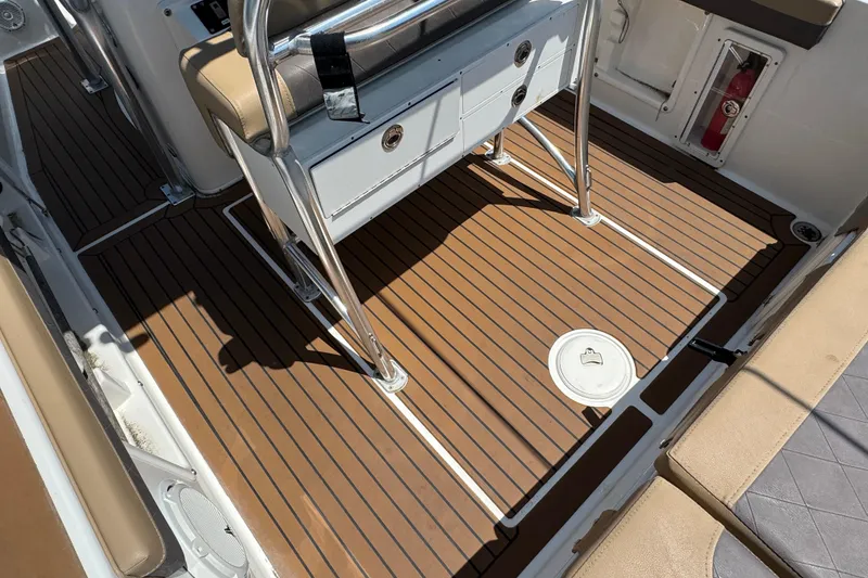 Slide: The Image of 2014 Century 2301 Center Console boat interior with teak flooring and seating. - 5
