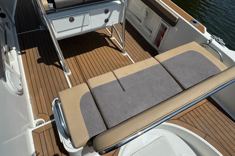 Slide: The Image of 2014 Century 2301 Center Console boat interior with cushioned seating and teak flooring. - 4