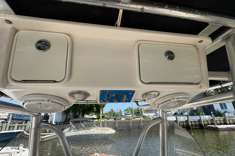 Slide: The Image of 2014 Century 2301 Center Console boat with overhead storage and speakers. - 17