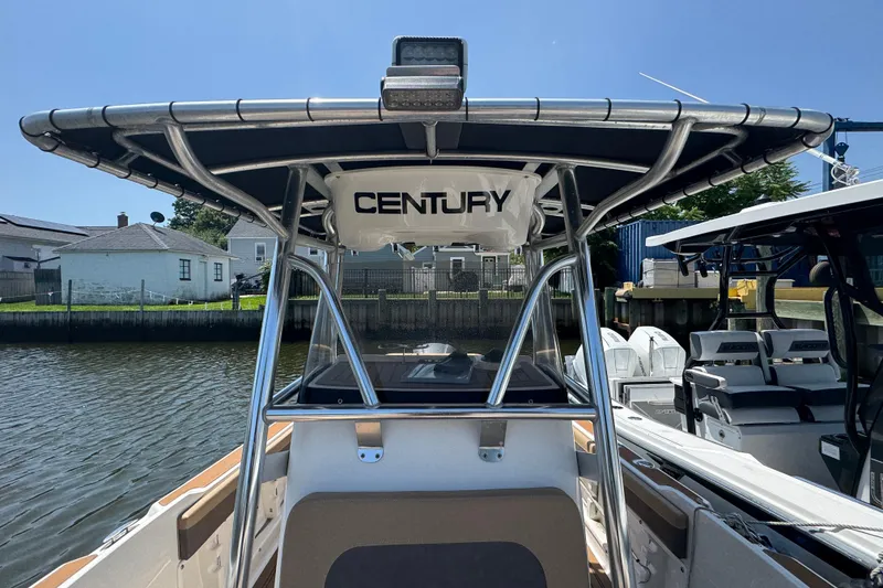 Slide: The Image of 2014 Century 2301 Center Console boat docked, featuring sturdy T-top and sleek design. - 22