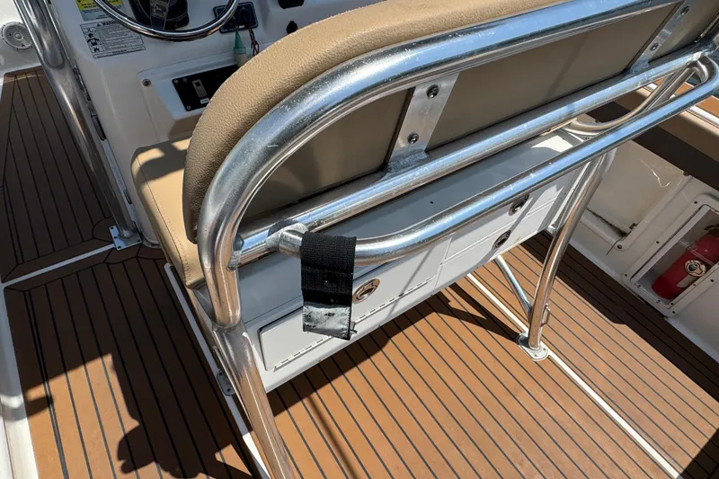 Slide: The Image of 2014 Century 2301 Center Console boat interior with tan seating and wood-style flooring. - 7