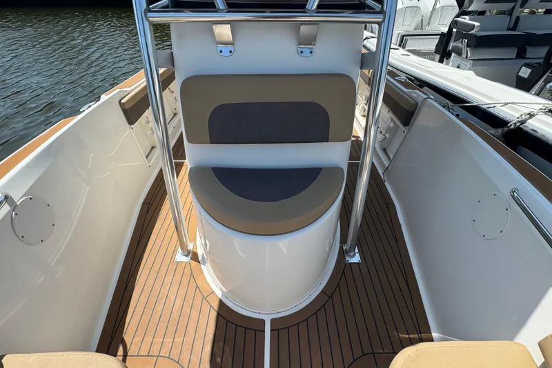Slide: The Image of 2014 Century 2301 Center Console boat interior with cushioned seating and wood-style flooring. - 21