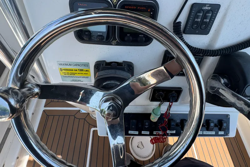 Slide: The Image of Steering wheel and controls of a 2014 Century 2301 Center Console boat. - 16
