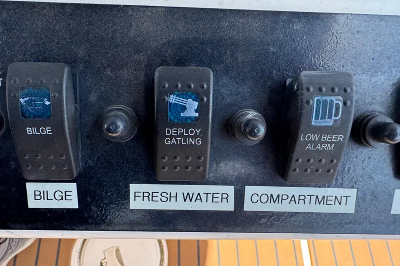 Slide: The Image of Control panel of a 2014 Century 2301 Center Console boat with humorous switch labels. - 10