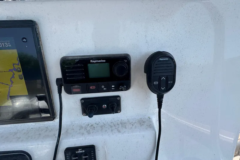 Slide: The Image of Raymarine marine radio and GPS on 2014 Century 2301 Center Console boat dashboard. - 14