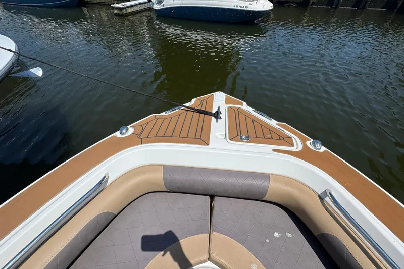 Slide: The Image of Bow view of a 2014 Century 2301 Center Console boat docked on calm water. - 20