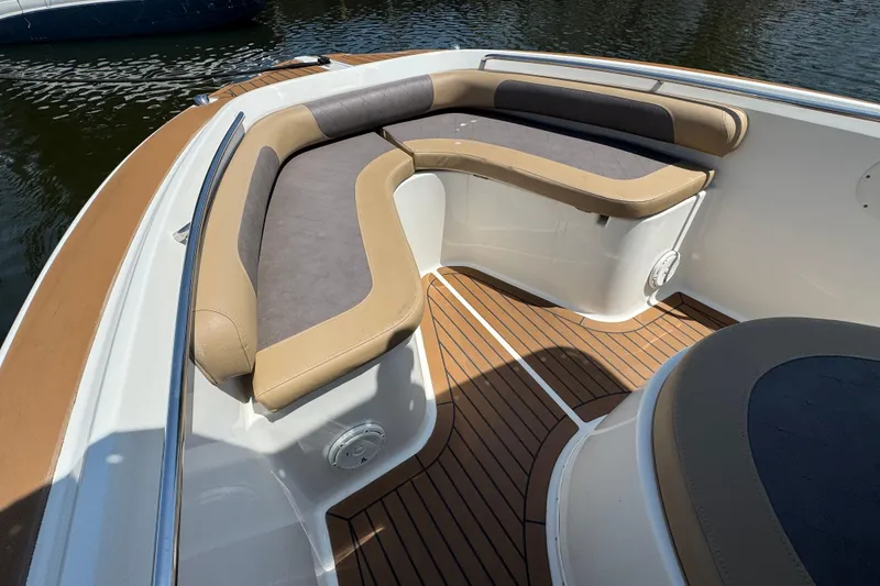 Slide: The Image of 2014 Century 2301 Center Console boat with cushioned seating and wood-patterned flooring. - 19