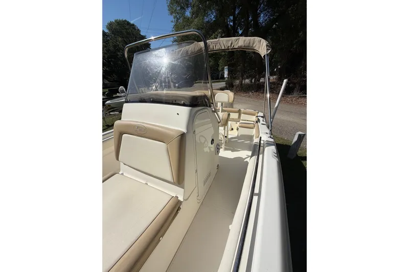 Slide: The Image of 2012 Scout 210 XSF boat interior with beige seating and windshield. - 12