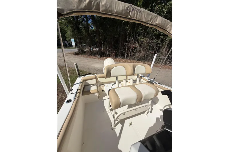 Slide: The Image of 2012 Scout 210 XSF boat interior with beige seating and canopy. - 14