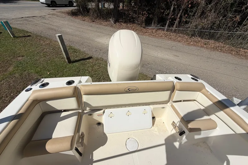 Slide: The Image of 2012 Scout 210 XSF boat interior with seating and outboard motor. - 15