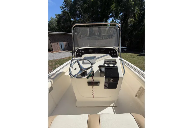 Slide: The Image of 2012 Scout 210 XSF boat cockpit with steering wheel and control panel. - 13