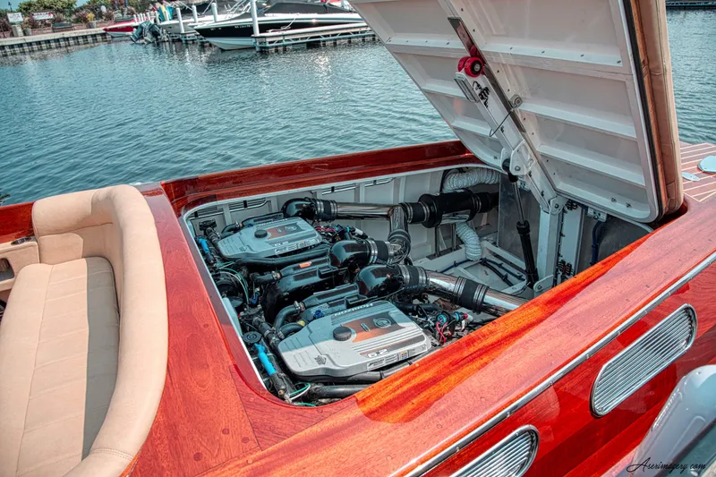 Slide: The Image of 2020 Custom Windlea Runabout boat with open engine compartment, docked by the water. - 20