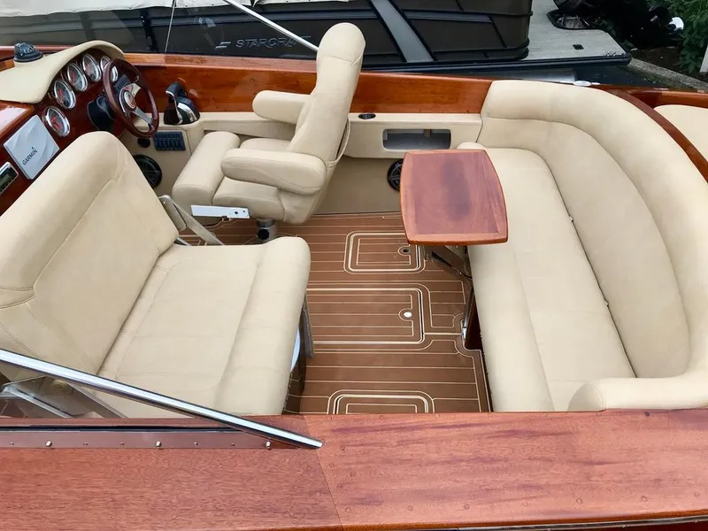 Slide: The Image of 2020 Custom Windlea Runabout interior with beige seating and wooden accents. - 16