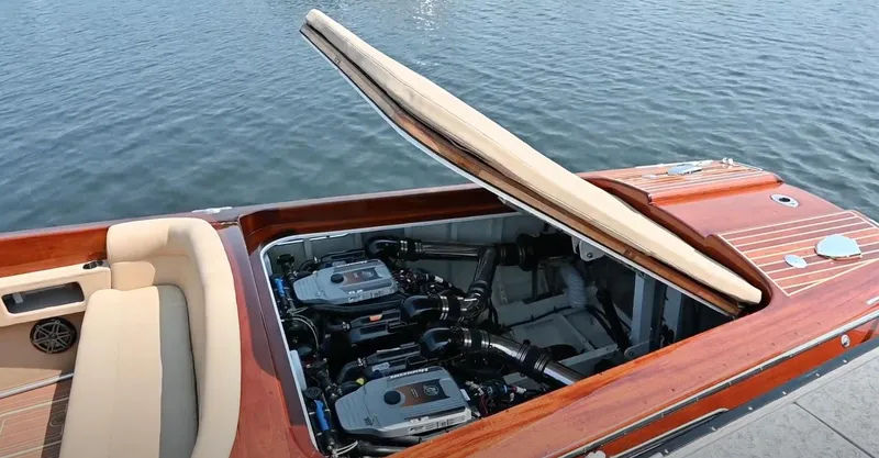 Slide: The Image of 2020 Custom Windlea Runabout boat with open engine compartment, docked by the water. - 19