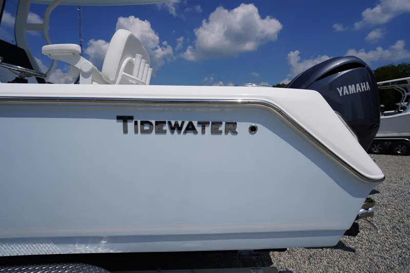 Slide: The Image of 2026 Tidewater 232 CC Adventure boat with Yamaha engine, under a clear blue sky. - 1