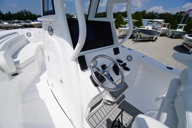 Slide: The Image of 2026 Tidewater 232 CC Adventure boat interior with modern helm and seating. - 33