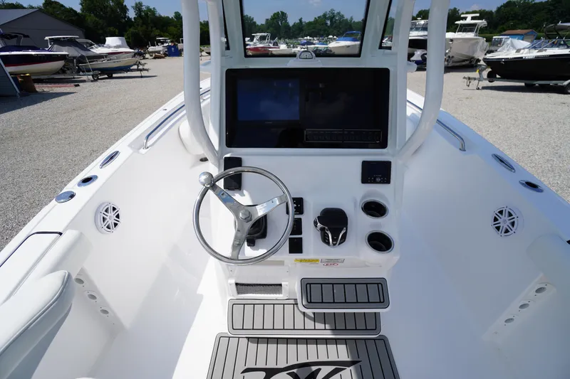 Slide: The Image of 2026 Tidewater 232 CC Adventure boat console with steering wheel and controls. - 35