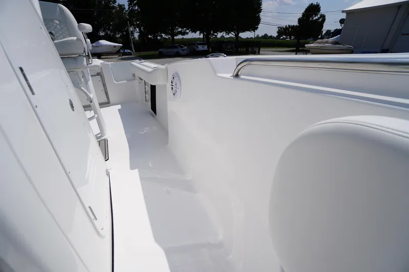 Slide: The Image of 2026 Tidewater 232 CC Adventure boat interior, showcasing sleek white deck and seating area. - 23