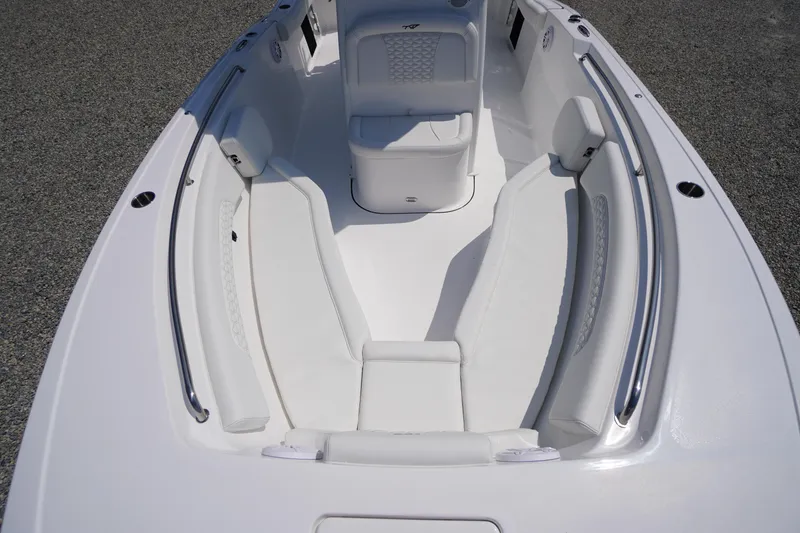 Slide: The Image of 2026 Tidewater 232 CC Adventure boat interior with white seating and stainless steel railings. - 8