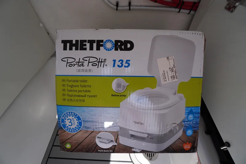Slide: The Image of Box of Thetford Porta Potti 135 portable toilet inside Tidewater 232 CC Adventure boat. - 31