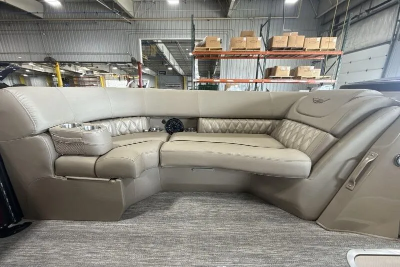 Slide: The Image of Luxurious seating on the 2026 Bennington 24 LXS Quadbench pontoon boat in a warehouse setting. - 7