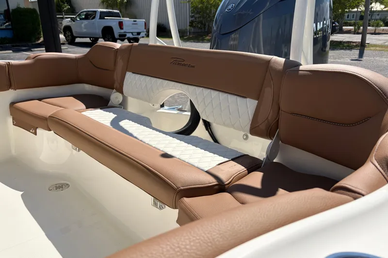 Slide: The Image of Interior seating of 2027 Pioneer 202 Islander boat with brown and white upholstery. - 10