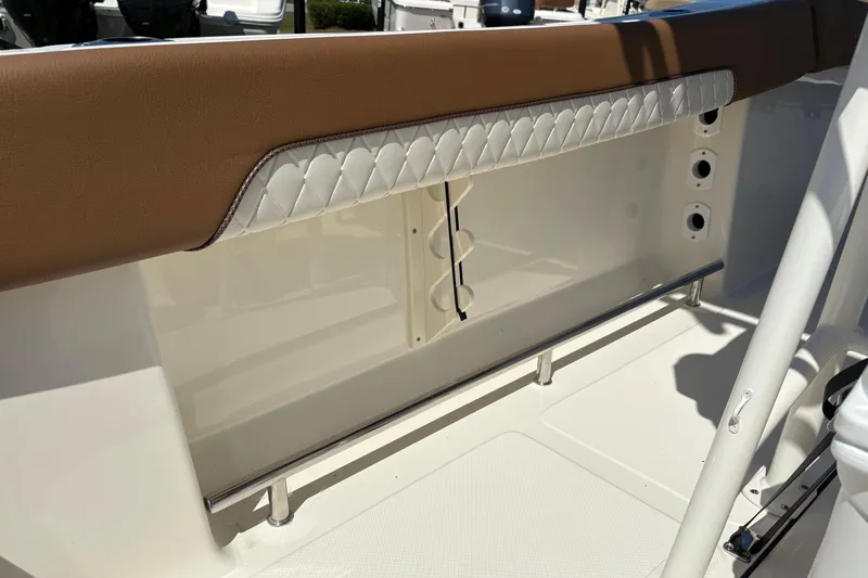 Slide: The Image of 2027 Pioneer 202 Islander boat interior with brown and white cushioned seating detail. - 16