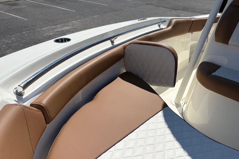 Slide: The Image of Interior seating of 2027 Pioneer 202 Islander boat with brown and white upholstery. - 28