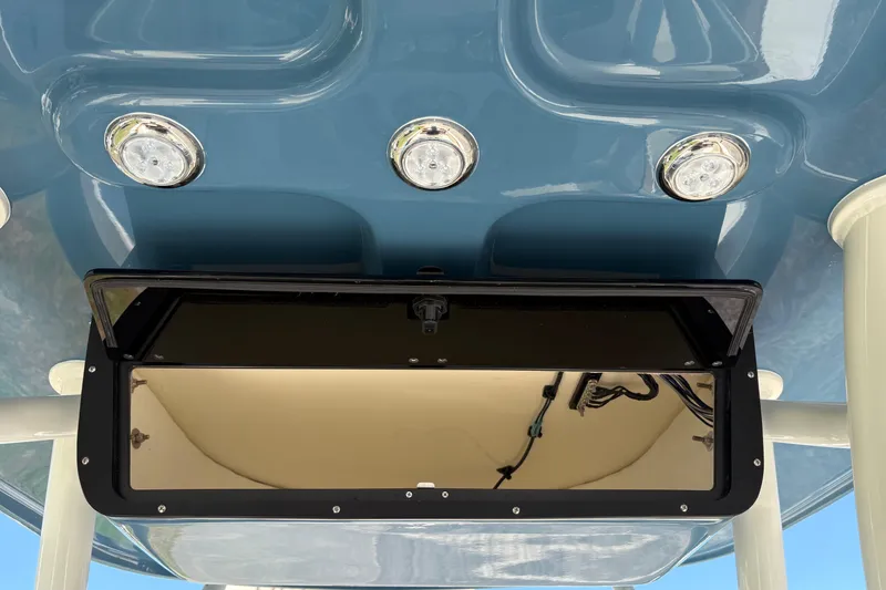 Slide: The Image of 2027 Pioneer 202 Islander boat roof with lights and open compartment. - 17
