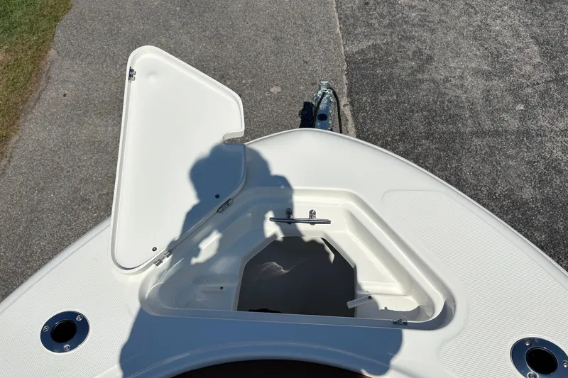 Slide: The Image of Open storage compartment on 2027 Pioneer 202 Islander boat deck. - 29
