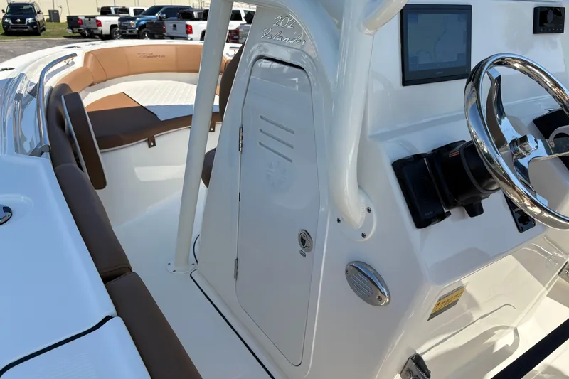Slide: The Image of Interior view of a 2027 Pioneer 202 Islander boat, featuring steering wheel and seating area. - 23