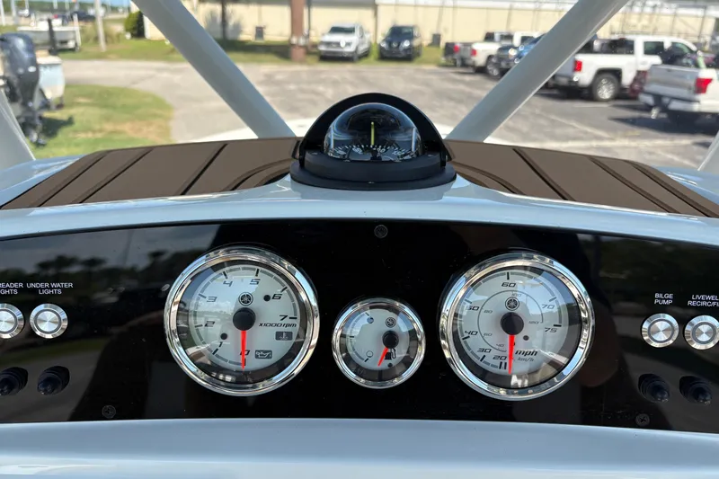 Slide: The Image of Dashboard of 2027 Pioneer 202 Islander boat with gauges and compass. - 21