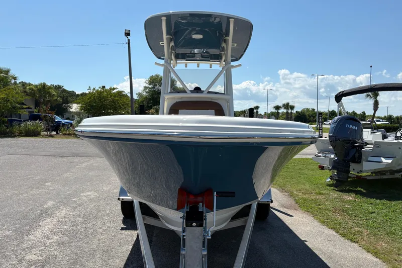 Slide: The Image of Front view of a 2027 Pioneer 202 Islander boat on a trailer under a clear blue sky. - 6