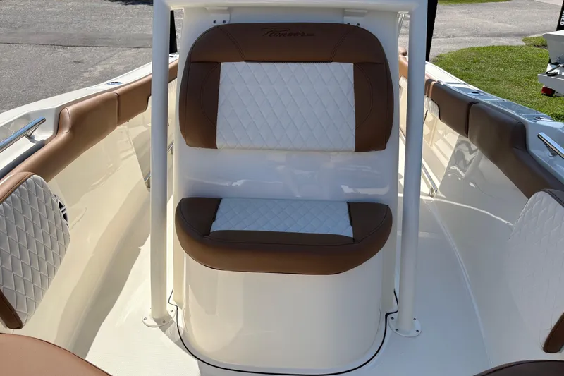 Slide: The Image of 2027 Pioneer 202 Islander boat interior with brown and white cushioned seating. - 26