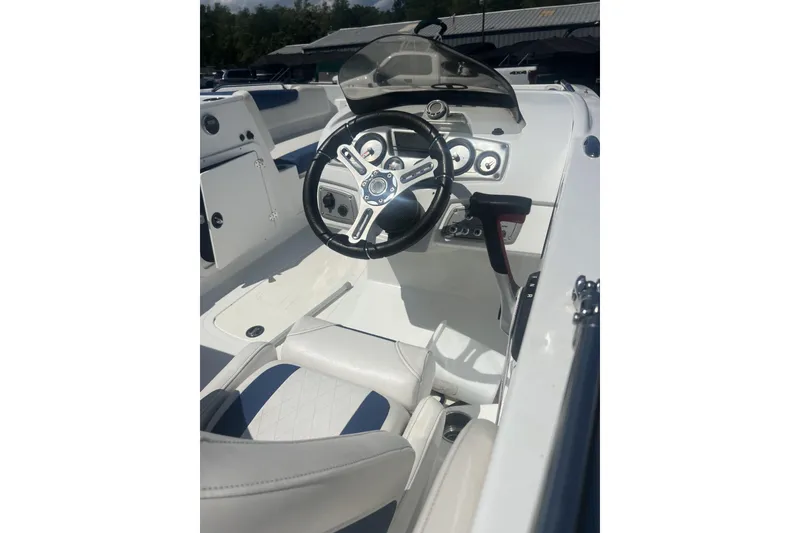 Slide: The Image of 2017 Tahoe 2150 boat cockpit with steering wheel and dashboard controls. - 9