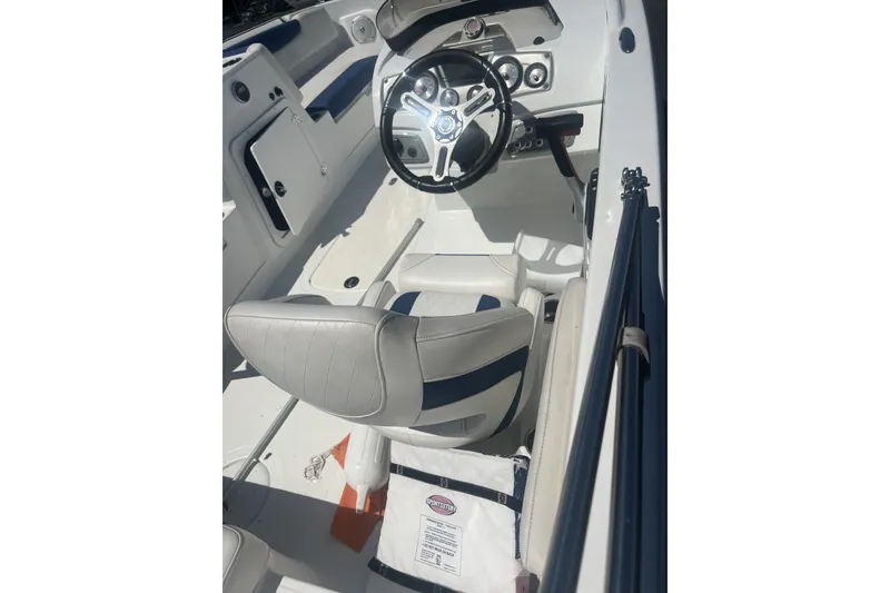 Slide: The Image of 2017 Tahoe 2150 boat interior with steering wheel and seating. - 10