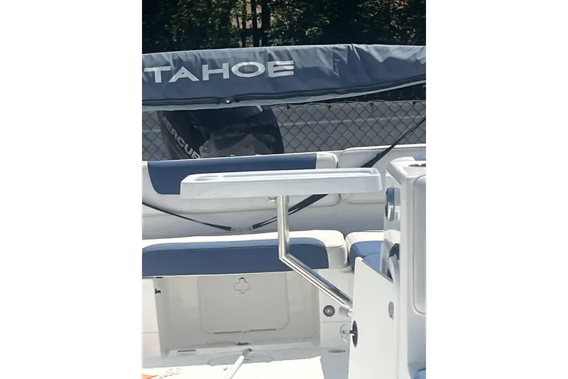 Slide: The Image of 2017 Tahoe 2150 boat interior with seating and table, featuring a covered engine. - 14
