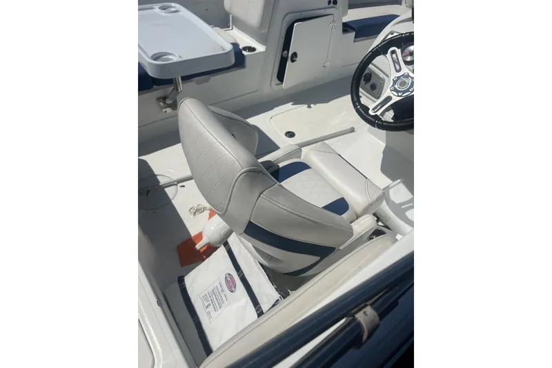 Slide: The Image of 2017 Tahoe 2150 boat interior with steering wheel and cushioned seating. - 7