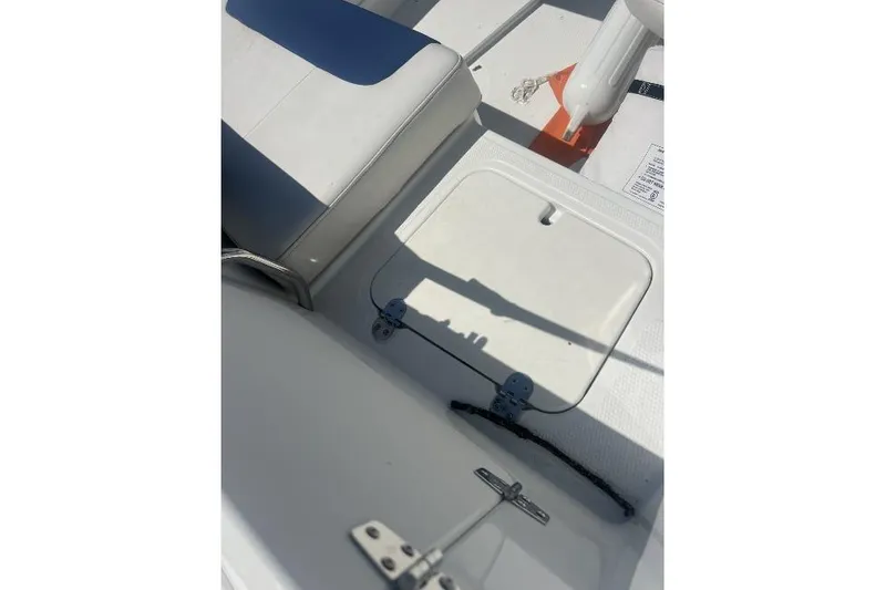 Slide: The Image of Interior view of a 2017 Tahoe 2150 boat showing seating and storage compartment. - 16