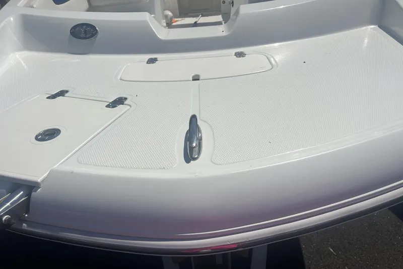 Slide: The Image of 2017 Tahoe 2150 boat deck with storage compartments and cleat. - 12