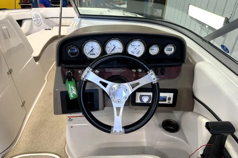 Slide: The Image of 2008 Four Winns H240 boat dashboard with steering wheel and instrument panel. - 32