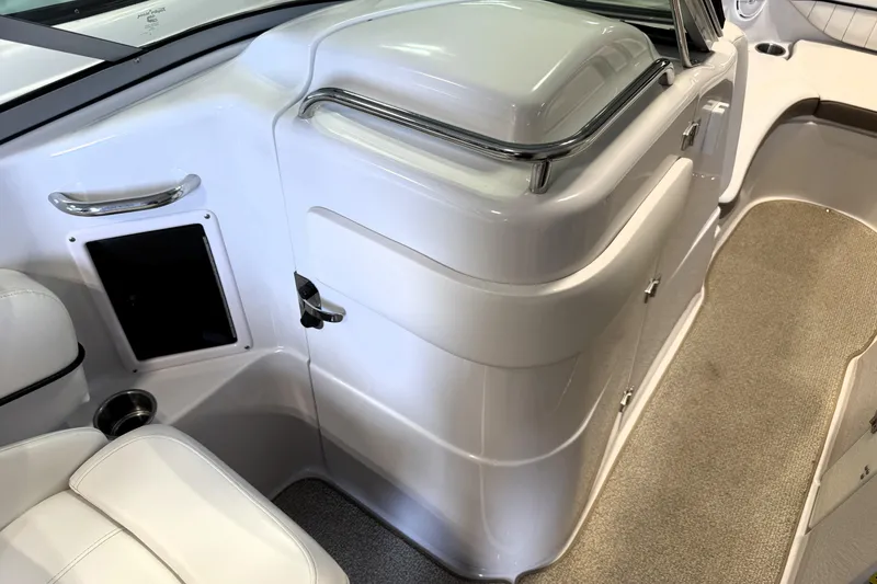 Slide: The Image of Interior of 2008 Four Winns H240 boat, featuring sleek white seating and storage compartments. - 30