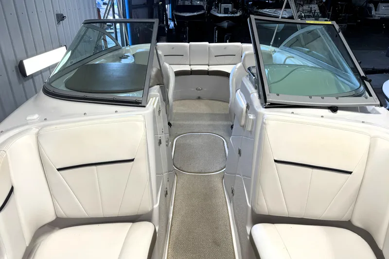 Slide: The Image of 2008 Four Winns H240 boat interior with white seating and open windshield. - 6